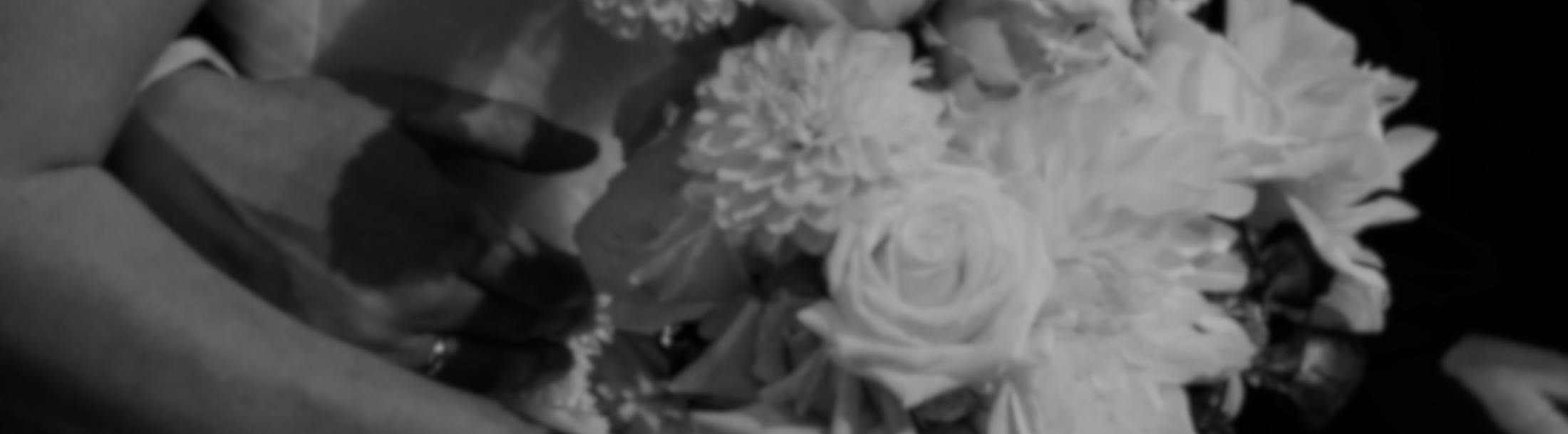 Black and white photo of a woman holding a wedding bouquet of flowers - Services