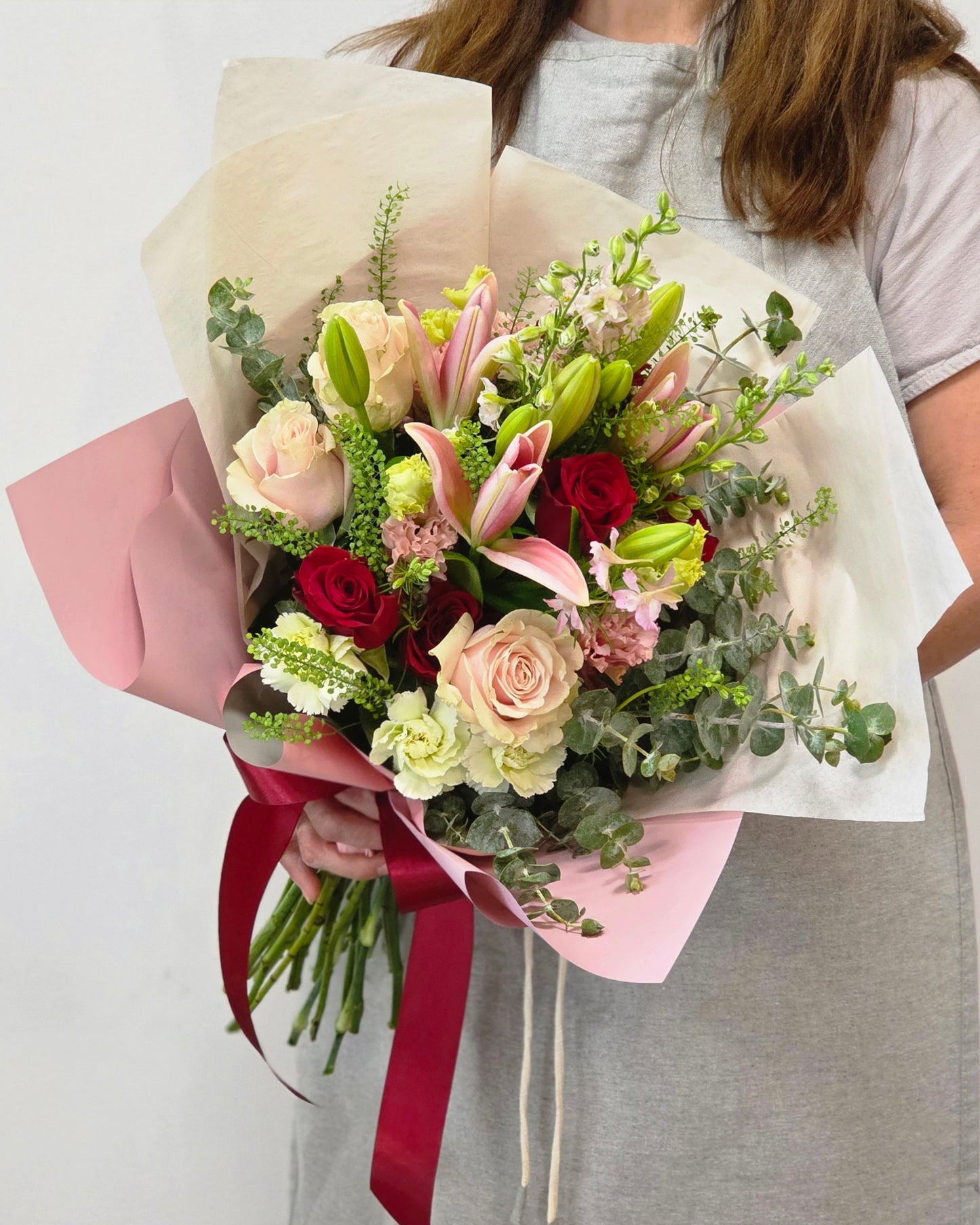 Photo of a woman holding a hand-tied bouquet of fresh flowers
