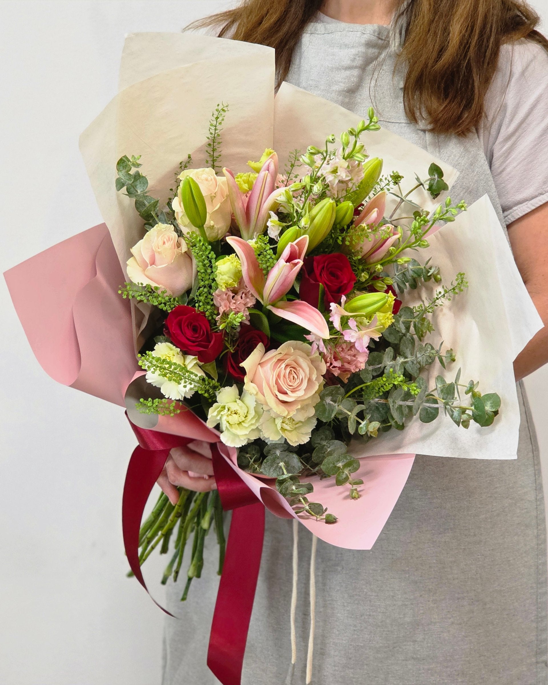 Photo of a woman holding a hand-tied bouquet of fresh flowers