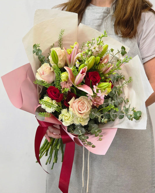 Photo of a woman holding a hand-tied bouquet of fresh flowers